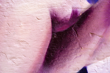 Purple dark abstract paint on a white wall. Close-up of a graffiti texture. Street art background.