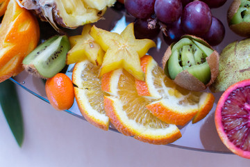 Beautifully sliced fruits on a festive table. Meals for guests during holidays and activities. Carvin fruit.