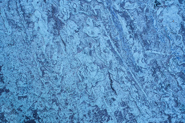 Fototapeta na wymiar Blue splashed dry paint on the road. Top view texture.