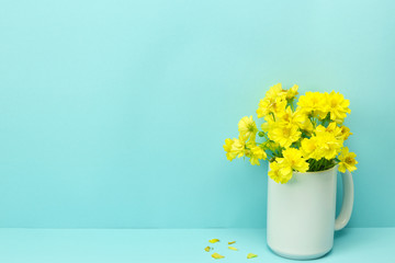 Yellow spike flowers in a vase.
