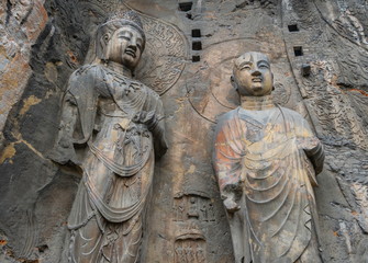 Big statue made in limestone of monks and bodhisattvas. The main cave (Fengxiangsi Cave) of Longmen Grottoes in Luoyang . A world heritage Site in Henan province, China. 