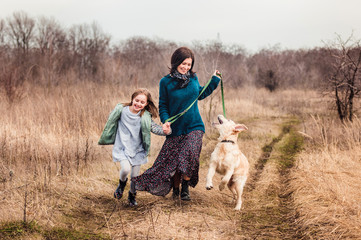 Dog with girl and woman outside