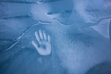 Human Hand Imprint on the Ice Wall in the Natural Cave during winter. Taken in Blackcomb Mountain, Whistler, British Columbia, Canada. Concept: Peace, Humanity, Unity