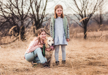 Girls with dog in nature