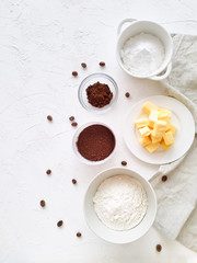 Ingredients for making chocolate cookies top view on a light background.