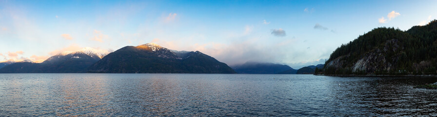 Porteau Cove, Howe Sound, near Squamish and Vancouver, British Columbia, Canada. Beautiful Panoramic Mountain Landscape View of a colorful morning sunrise in winter. Nature Background Panorama