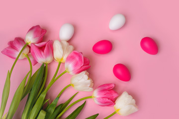 Happy Easter! Bright plastic Easter eggs on a pink background. Decorating the kitchen for Easter on a Sunny day. Greeting card.