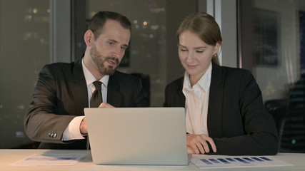 The Business people Discussing on Laptop Screen at Night