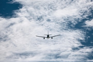 Fototapeta na wymiar Silhouette of flying airplane