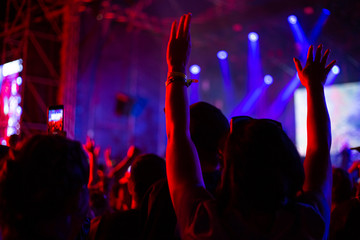 woman raised her hands up at a concert