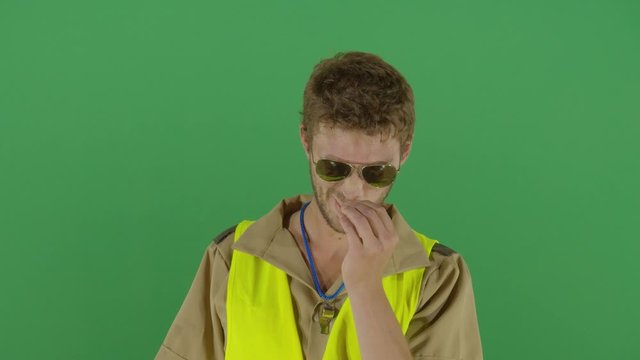 Adult Man Police Officer Picking His Nose And Throws A Bugger To The Camera Studio Isolated Shot Against Green Screen Background