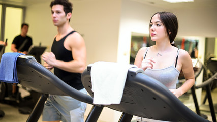 Fototapeta na wymiar People running on the treadmill in a gym