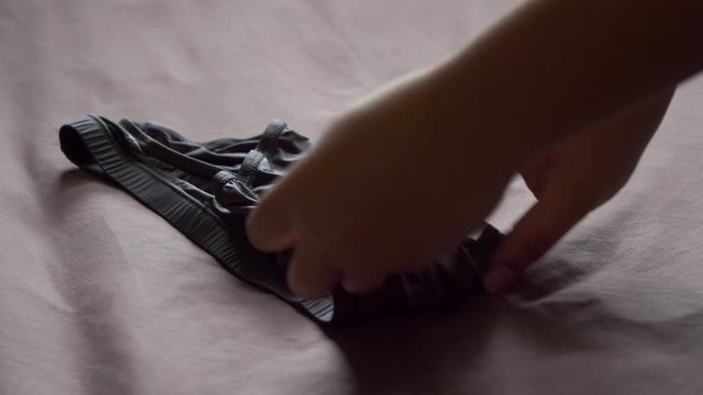 Men use their hands to fold men's underwear to keep it organized and easy to store and use. 4K, 29.97fps