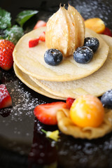 Organic pancake topping with honey, berry and fruit healthy food.