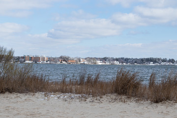 Snow patches along the beach of the riverfront in Yorktown, Virginia, by the inland beach.