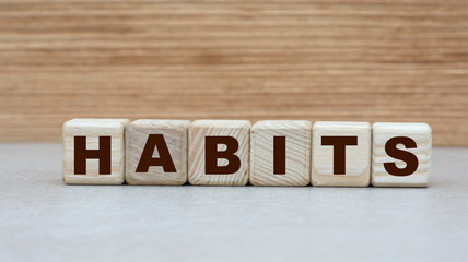 concept of the word habits on cubes on a wooden background