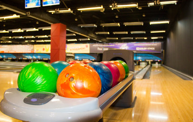 Fototapeta na wymiar Colorful bowling balls. Multi- colored bowling balls. The equipment for bowling.