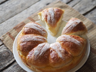 Festive Easter, Christmas or everyday bread rolls on a wooden rustic ancient table.Homemade cake. Side view.