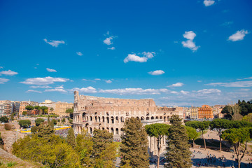 Fototapeta na wymiar City panorama Rome, Italy Colosseum or Coliseum ancient ruins background blue sky with clouds