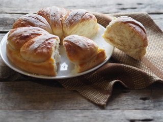 Festive Easter, Christmas or everyday bread rolls on a wooden rustic ancient table.Homemade cake. Side view.