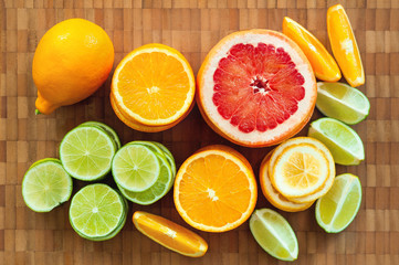 Fototapeta na wymiar sliced citrus fruits lie on a wooden board. orange, lemon, lime grapefruit. top view
