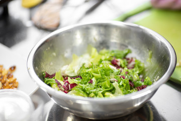Vegetable salad green with dressing olive oil in steel plate