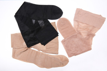 different new pantyhose on white background