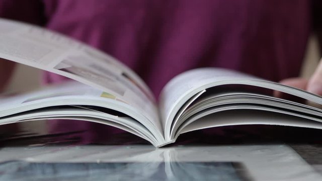 Male Hand Flipping Book Pages During Reading. Close Up shot. Guy Reading Book
