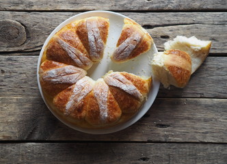 Festive Easter, Christmas or everyday bread rolls on a wooden rustic ancient table.Homemade cake. The view from the top.