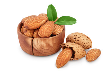Almonds nuts with leaves in wooden bowl isolated on white background with clipping path and full...