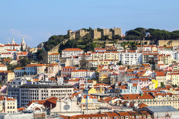 Castle overlooking historic city centre on sunny day