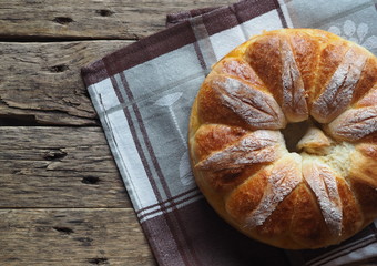 Festive Easter, Christmas or everyday bread rolls on a wooden rustic ancient table.Homemade cake. The view from the top.
