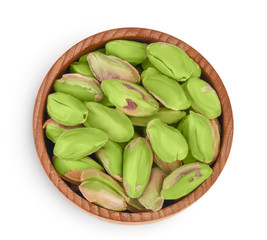 peeled pistachio in wooden bowl isolated on white background with clipping path and full depth of field. Top view. Flat lay