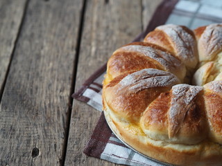 Festive Easter, Christmas or everyday bread rolls on a wooden rustic ancient table.Homemade cake. Side view.