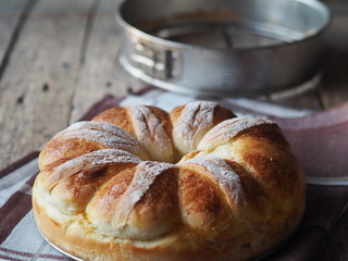 Festive Easter, Christmas or everyday bread rolls on a wooden rustic ancient table.Homemade cake. Side view.