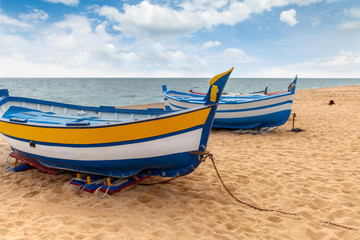 Fishing boats by the sea on a sunny day.