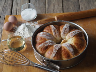 Festive Easter, Christmas or everyday bread rolls on a wooden rustic ancient table.Homemade cake. Side view.