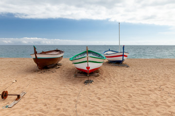 Naklejka na ściany i meble several colorful fishing boats by the sea on a sunny day