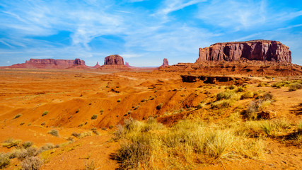 A Horse and Rider at John Ford Point surrounded by the massive Red Sandstone Buttes and Mesas in Monument Valley, a Navajo Tribal Park on the border of Utah and Arizona, United States