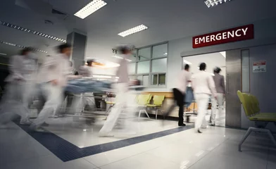 Fotobehang A motion blurred photograph of a patient on stretcher or gurney being pushed at speed through a hospital corridor.New corona virus (novel Coronavirus 2019 disease,COVID-19,nCoV). © chokchaipoo