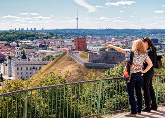 Fototapeta premium Women viewing Gediminas Tower and the Lower Castle in Vilnius