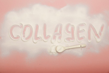 Collagen powder on pink background. Extra protein intake. Natural beauty and health supplement for skin, bones, joints and gut. Plant or fish based. Flatlay, top view. Copy space for your text.