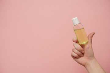Female hands holding bottle with antibacterial gel. Antiseptic hand gel for hands disinfection and cleaning during flu virus outbreak, coronavirus epidemic and infectious diseases      