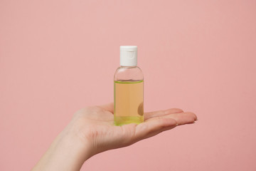 Female hands holding bottle with antibacterial gel. Antiseptic hand gel for hands disinfection and cleaning during flu virus outbreak, coronavirus epidemic and infectious diseases      