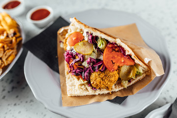 Falafel kebab in bred on bright background, fast food