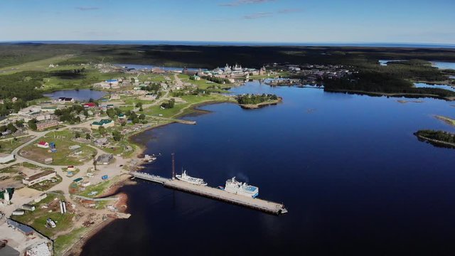 Smooth cinematic shot of the Solovetsky monastery and Solovetsky village from Tamara&rsquo;s pier on a clear sunny day.