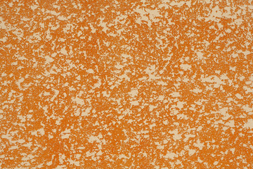 Decorative plaster of orange color. Rough plaster