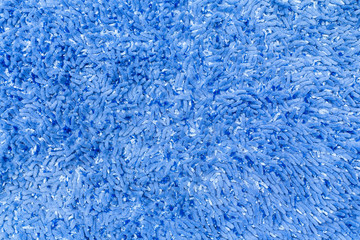 Fototapeta na wymiar Blue carpet with a long pile close-up. Blue background