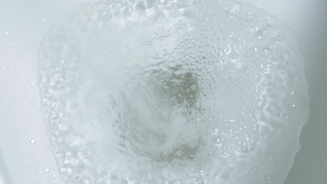 water is swirling in the toilet flush to clean and water being flushed in a toilet bowl.4k 25fps