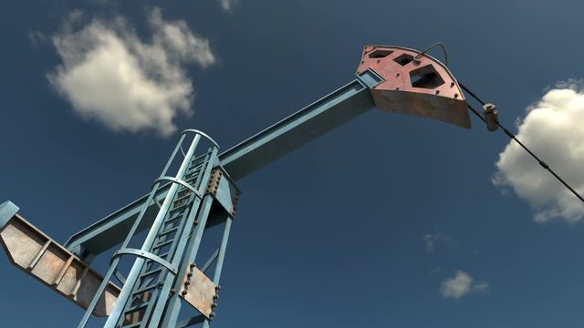 Low angle view of oil pump jack working and pumping crude oil under blue sky. Fossil fuel energy made from crude oil is the cheapest and the most profitable energy source in power generation industry.